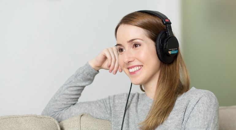 Uśmiechnięta Kobieta Słucha Audiobooka