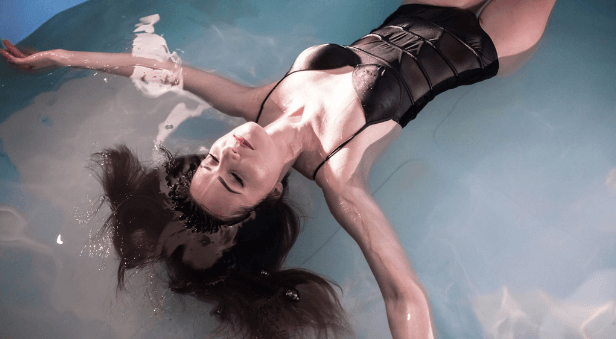 Kobieta Unosi na na Wodzie podczas Sesji Floatingu